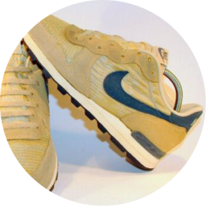 Tan Nike running shoe with navy swoosh that used Sorbothane material