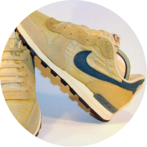 Tan Nike running shoe with navy swoosh that used Sorbothane material