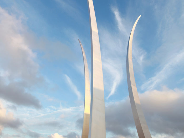 United States Air Force Memorial three spires soaring into a partly cloudy blue sky